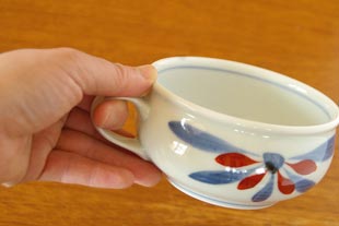 砥部焼・梅山窯 花もようのスープカップを手に持って
