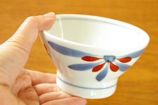 砥部焼・梅山窯 はなもようの茶碗(小)を手に持って
